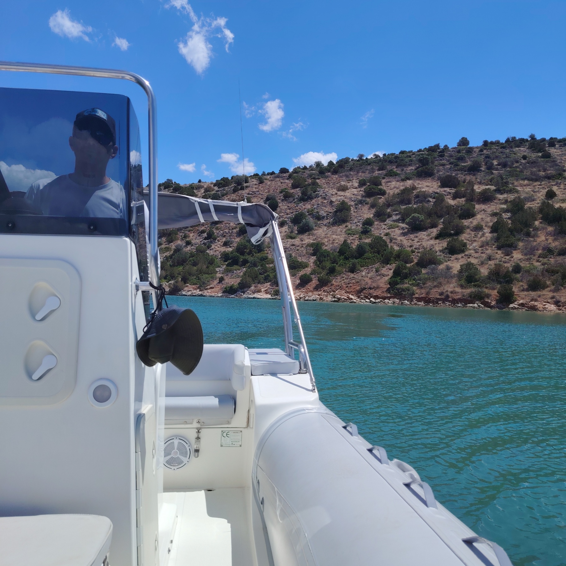 Skipper Pierre steering into a quiet cove