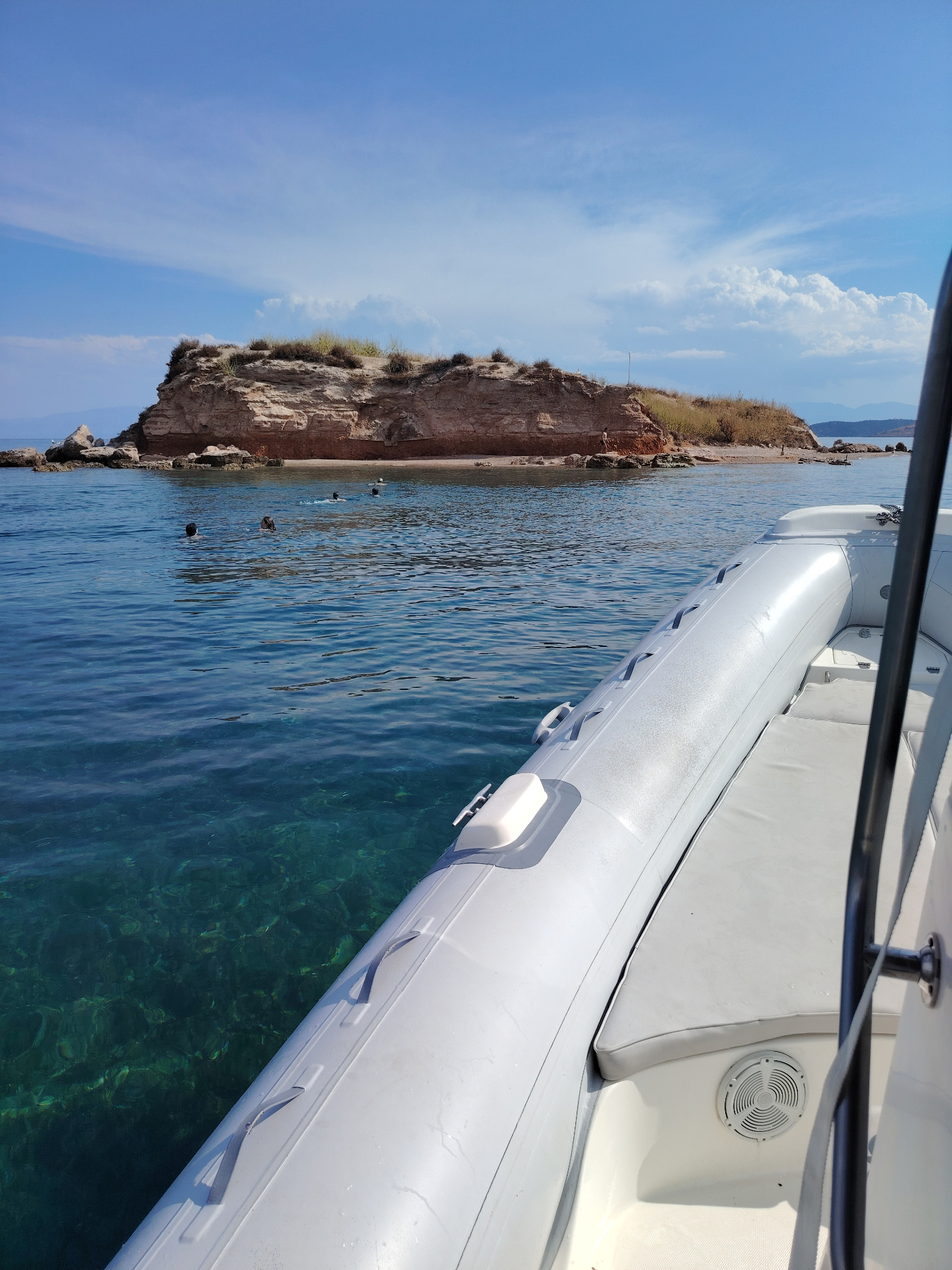 Re:Connect RIB anchored in clear turquoise water near a rocky islet