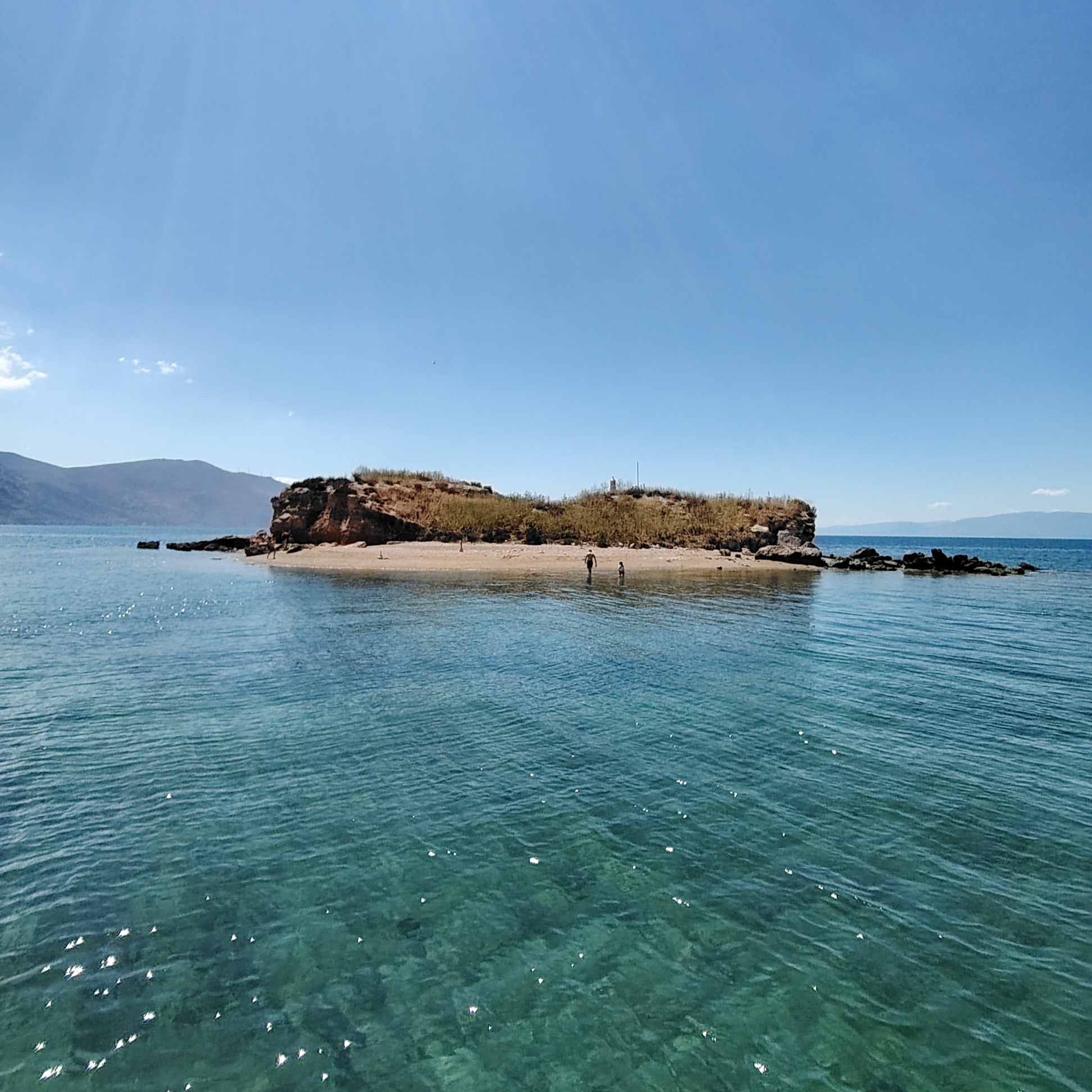 Tiny island with sandbar in the Gulf of Corinth