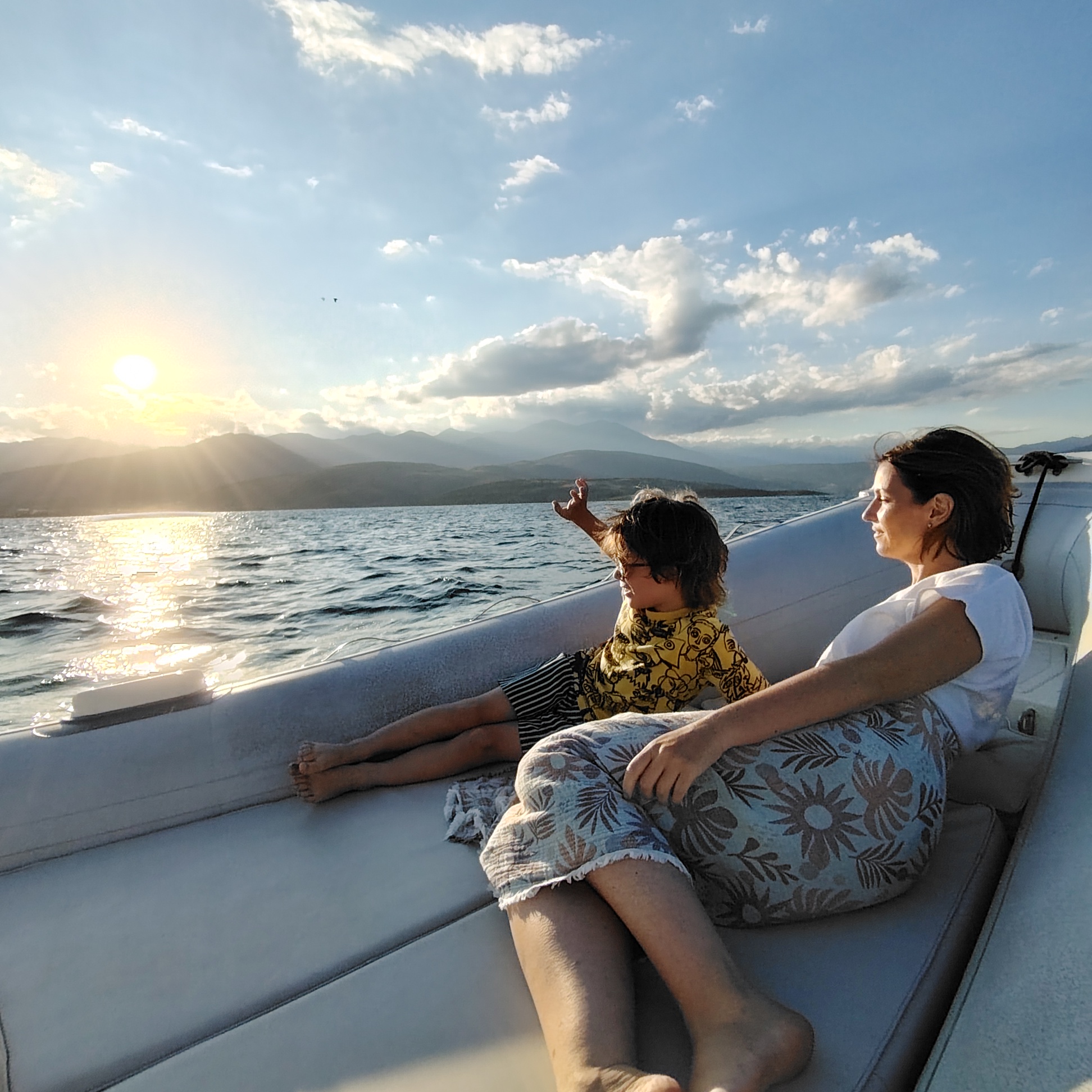 Mother and child watching the sunset from the bow
